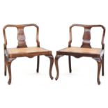 A pair of late 19th century mahogany occasional chairs, with low splat backs and caned seats