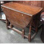 An oval oak drop leaf table, on block turned supports, 91cmL