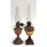 Two oil lamps, both with glass chimneys, 58cmH and 54cmH including chimneys