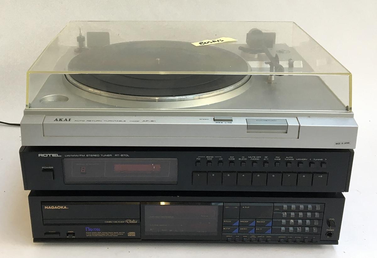 An Akai model AP- turntable; together with a Rotel RT-870L stereo tuner, and a Nagaoka CD player