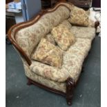 An early 20th century Italian three seater sofa, shaped rail and scolling acanthus capped