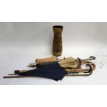 A number of vintage umbrellas and walking sticks; together with a large studio pottery umbrella