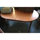 A mid-century style oval extending dining table, on tapered legs, approx. 163cmW when closed
