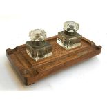 A late 19th/early 20th century oak inkstand having two square glass inkwells, cut glass faceted