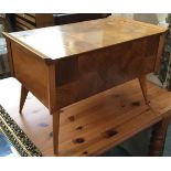 A mid-century sewing box, with hinged lid and removable sliding tray, on splayed legs, 66x38x42cmH