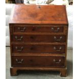A 20th century bureau, fall front above four drawers, with key, on bracket feet, 65cmW