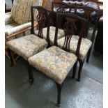 A set of four mahogany dining chairs, with pierced splat backs and stuffover seats, on cabriole legs