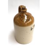 A stoneware flagon with loop handle, marked 'W.E. Randall, late W.H. Chick, Wine Merchant,