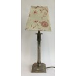A trench art style table lamp on plinth base