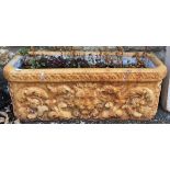 A terracotta trough planter with lion mask decoration, 71cmW