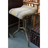 An unusual brass and upholstered swivel stool with brass back rail, 67cmH