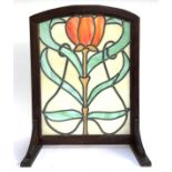 An Art Nouveau style glazed fire screen, set within an oak frame, 71cmH