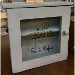 A painted pine glass front hanging cabinet, the glass hand stencilled 'No.5 Chanel Paris', 47cmW