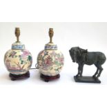 Two ceramic Oriental lamps on hardwood bases, each 33.5cmH; together with a resin figure of a horse,