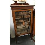 An Edwardian glazed display cabinet containing a set of Waverley novels, 66x35x136cm