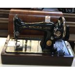 A Singer sewing machine, s/n EC178964, in domed mahogany carry case with key