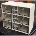 A vintage set of glass kitchen drawers, six large flanking six smaller drawers, 38.5cmW