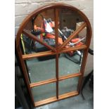 A pine framed wall mirror, domed top with separated plates, 109cmH