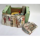 A mixed box of knitting paraphernalia and vintage sewing patterns
