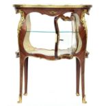 A French Belle Epoque display table, of bombe form, sans traverse veneer, scrolling ormolu mounts
