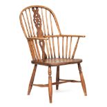 A 19th century wheel back Windsor chair, shaped seat on turned supports and H stretcher