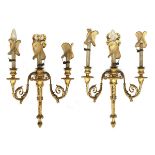 An exceptionally fine pair of George III giltwood three arm wall sconces, each arm with scrolling