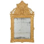 An 18th century French carved giltwood wall mirror, the arched pierced cresting with foliate carving