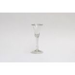 An 18th century ale glass with flared trumpet bowl, on plain stem with folded foot, 15.5 high