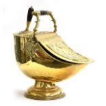 A Regency brass coal scuttle with embossed husk bead detail and turned ebony handle, with original