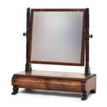 A Victorian adjustable dressing mirror, on turned and fluted supports, the rectangular base with