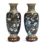 A pair of late 19th century Chinese cloisonné enamel vases on hardwood stands, depicting cherry