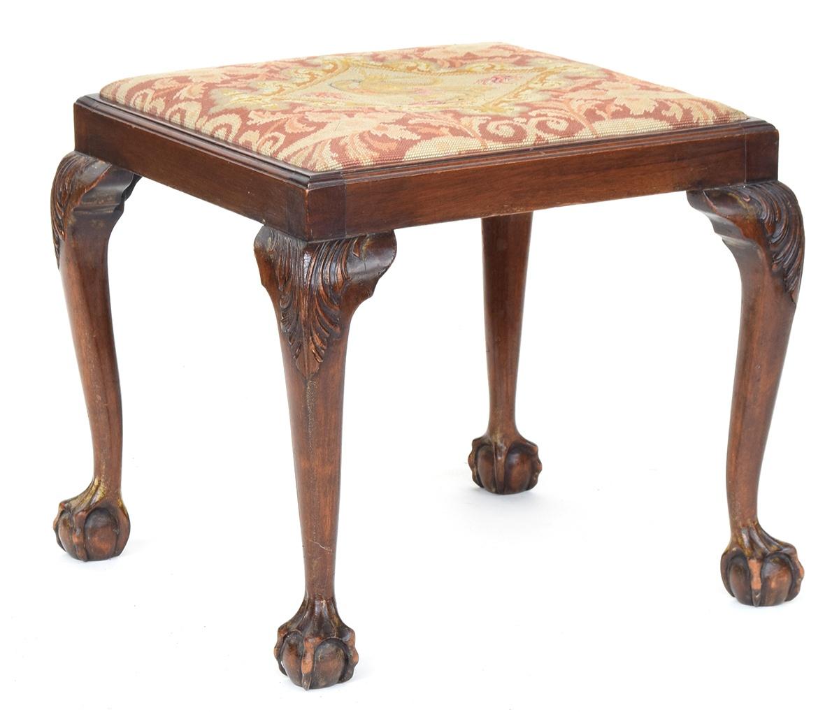 A 19th century foot stool with needlework drop in seat, on carved cabriole legs with ball and claw