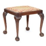 A 19th century foot stool with needlework drop in seat, on carved cabriole legs with ball and claw