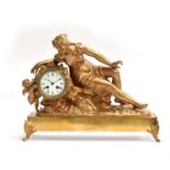 A 19th century French gilt metal ormolu style figural mantel clock, in the form of a reclining