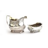 A George III silver milk jug and sugar bowl by Alice & George Burrows II, London 1807, half fluted