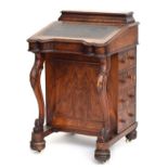 A Victorian walnut davenport desk, with waisted box superstructure above a leather inset slope