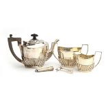 A late Victorian three piece silver teaset by George Nathan & Ridley Hayes, Chester 1899 and 1900,