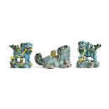 A set of three glazed polychrome porcelain foo dogs (af), two of which 9.5cm high, the other 8cm