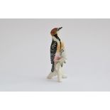 A Karl Ens porcelain figurine of a woodpecker, 24cm high, marked to base
