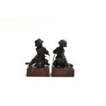 A pair of 19th century bronze cherub figures upon red marble plinths, each 17.5 cm high