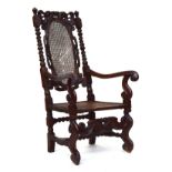 A Charles II open armchair, crown and scroll carved cresting rail over an oval caned panel within