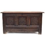 A 17th century oak three panel mule chest, with carved rosette decoration, candlebox in interior,