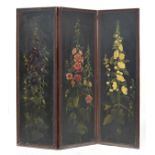 An early 20th century tooled leather three panel screen, painted with flowers, 182cm high, each