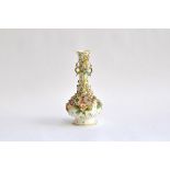 A twin-handled Coalbrookdale style bottle shaped vase, florally encrusted and heightened in gilt,