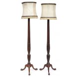 A pair of carved mahogany standard lamps, reeded columns with wheatsheaf carving, on tripod cabriole