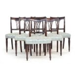A set of six Regency dining chairs, with lattice backs above stuffover seats, on turned legs
