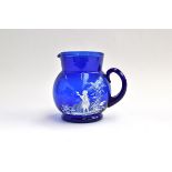 A Mary Gregory style cobalt blue glass jug, with white enamel decoration of a young girl holding a