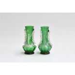 A pair of Mary Gregory style green glass vases with scalloped edge detailing (af), each painted with