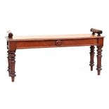 A late 19th century mahogany hall bench by James Shoolbred, the long seat with bolster roll ends