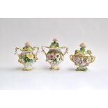 Three Coalbrookdale style twin handled floral encrusted lidded porcelain potpourri pots, each
